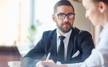 Businessman talking to his colleague at meeting
