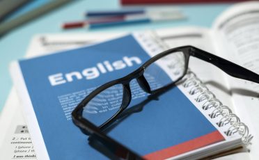 english-book-with-glasses-table-min